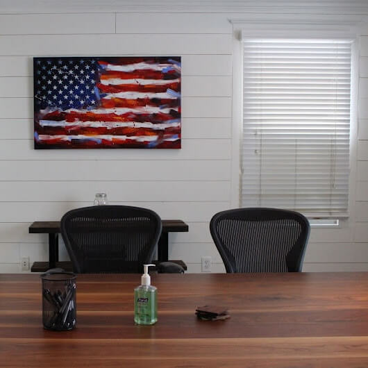 Kalka Law Group personal injury lawyers in Lawrenceville, GA, meeting room with a flag